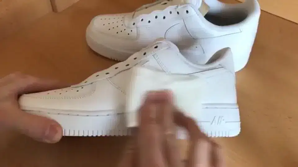 Hands preparing an Air Force 1 in the StyleReels studio